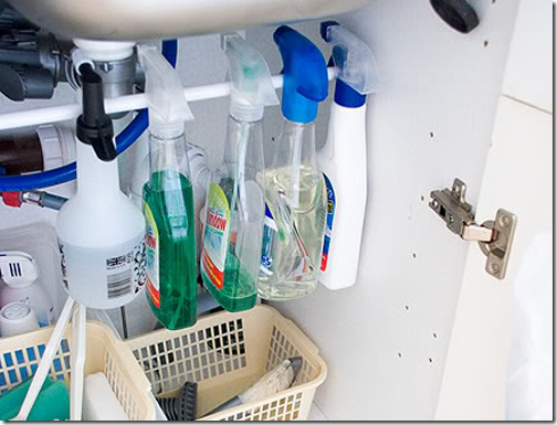 Install a tension rod to hang cleaning products with spray-bottle heads.