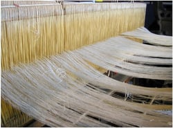 Minitab helped textile producers create the perfect mix of wrinkle-free cotton fabric. Here a textile loom is at work making thread from harvested cotton that will be used to make cotton clothing.