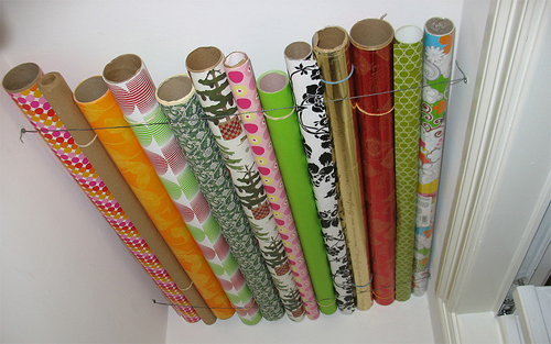String a piece of wire at the top of a closet to store wrapping paper for easy access.