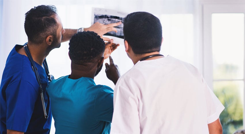 Clinicians examining a radiograph
