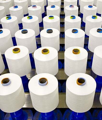Spools of yarn produced by Unifi Manufacturing. 