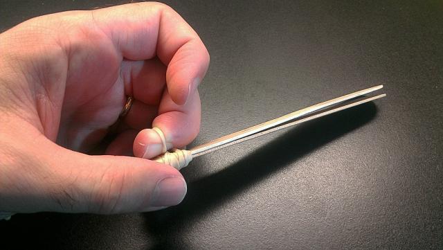 Winding the rubber band 8 times around cuts off the circulation in the finger tip.